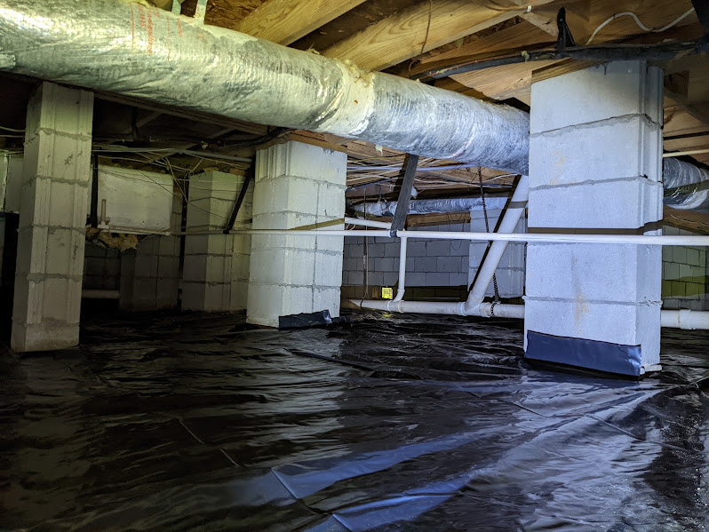 Clean, dry crawlspace with a smooth vapor barrier and painted block piers